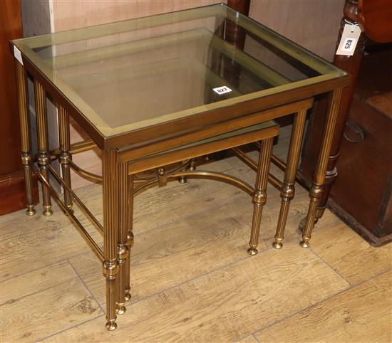 A nest of three French brass and glass tables W.56cm